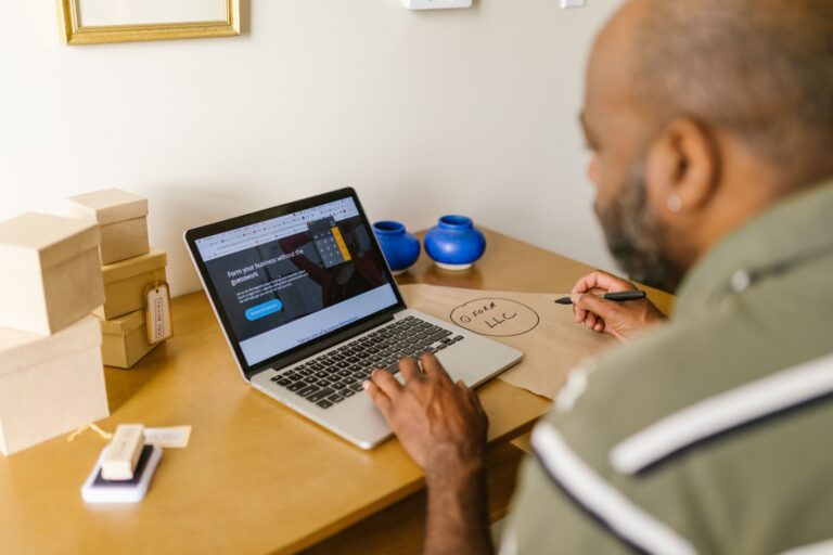 Small business owner using a laptop at a desk